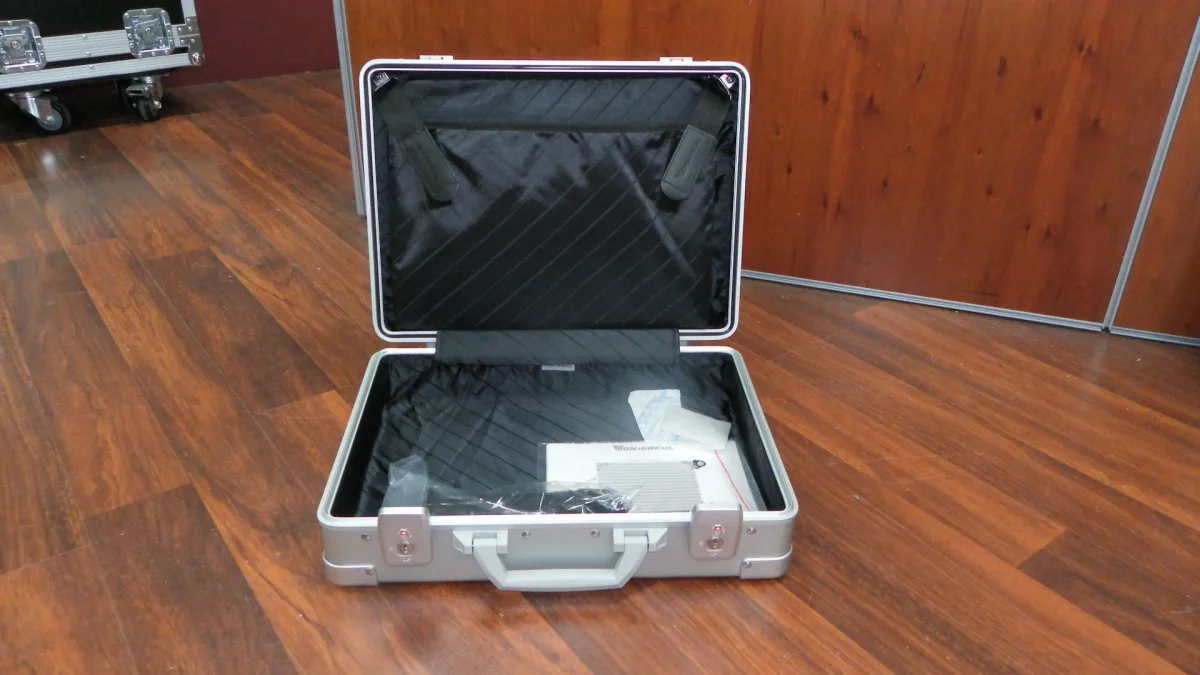 Open silver attaché case with a quilted document panel in the lid and key locks