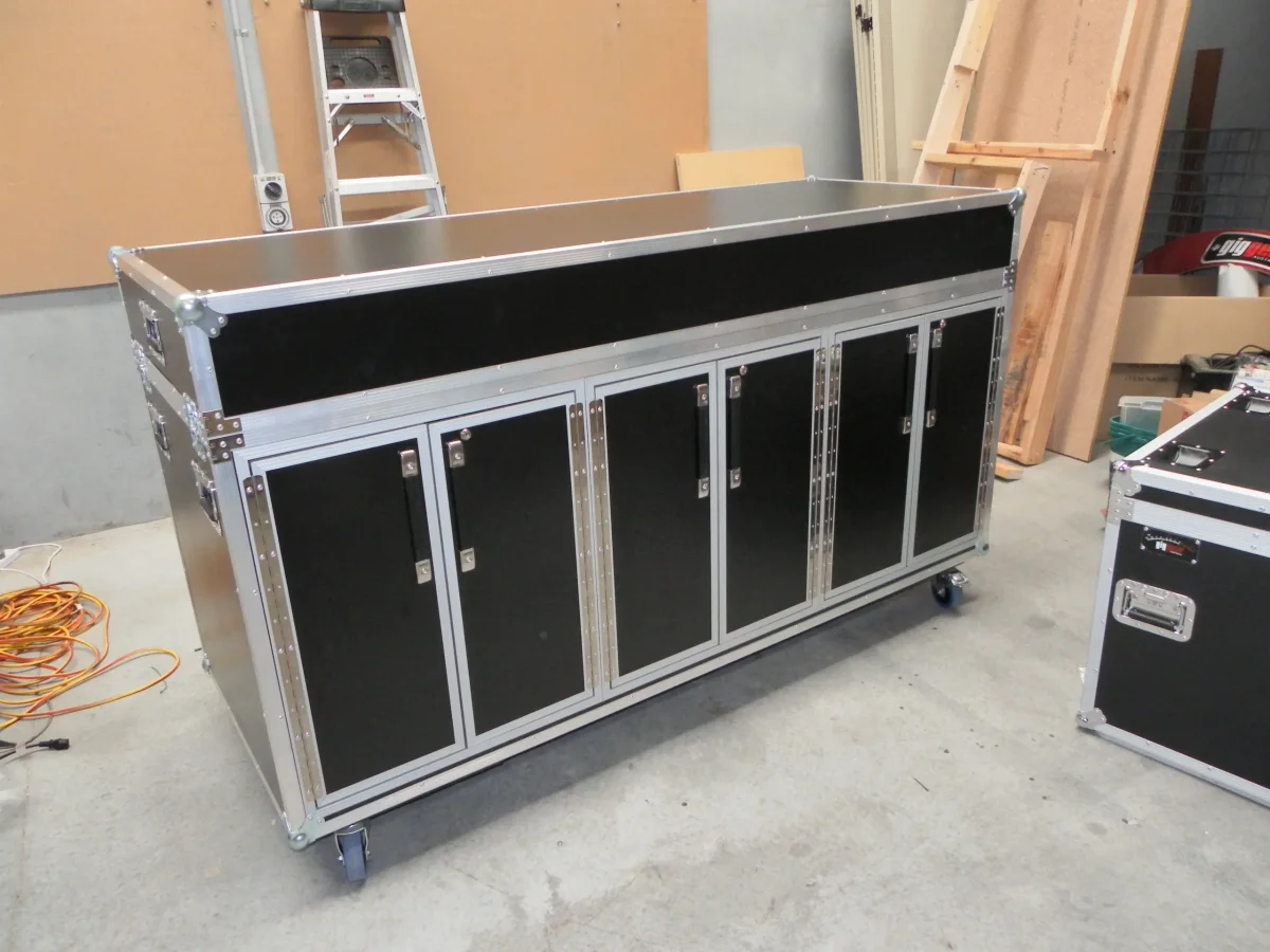 Long road case cabinet with six lockable doors and a lift-off lid, mounted on castors