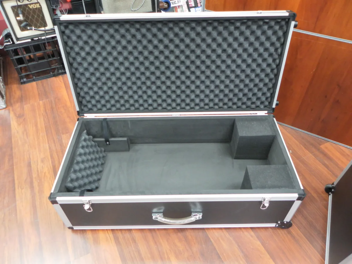 Open black case with a convoluted foam lid and block foam packed to hold equipment