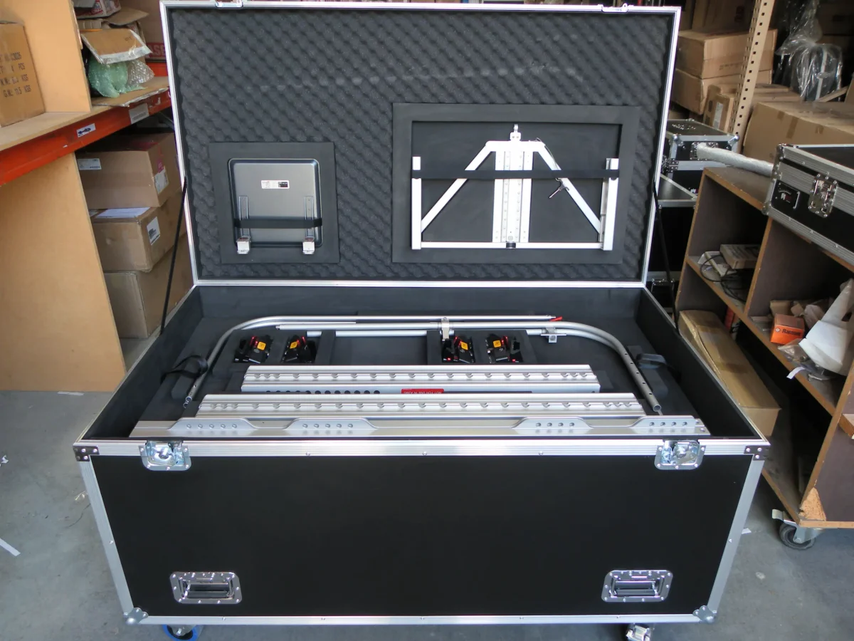 Open road case packed with aluminium staging rails and a folding frame stowed in the lid
