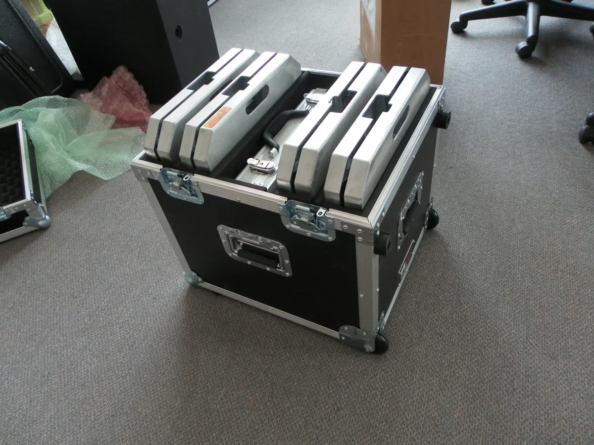 Road case holding machined aluminium staging plates stacked on edge