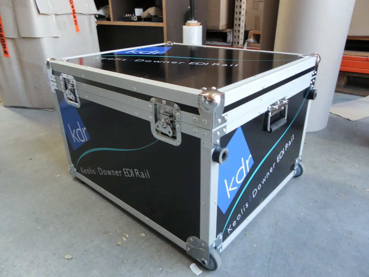 Wheeled black flight case printed with Keolis Downer EDI Rail branding