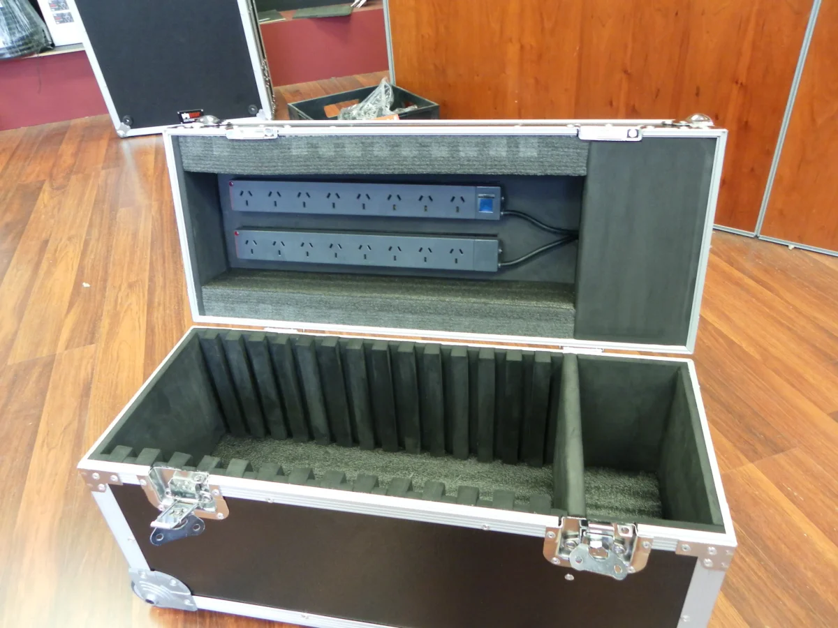 Flight case with vertical foam dividers and two power distribution boards mounted in the lid