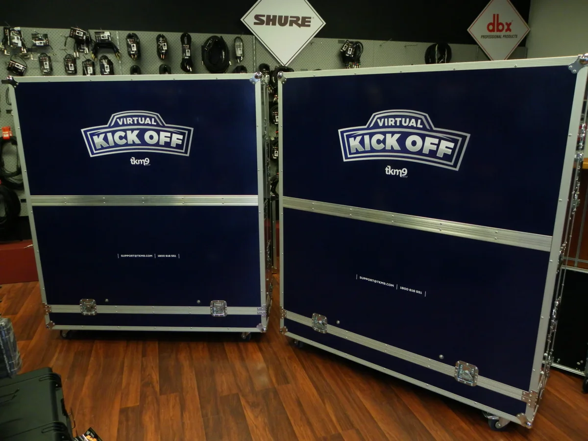 Pair of navy road cases printed with Virtual Kick Off event branding