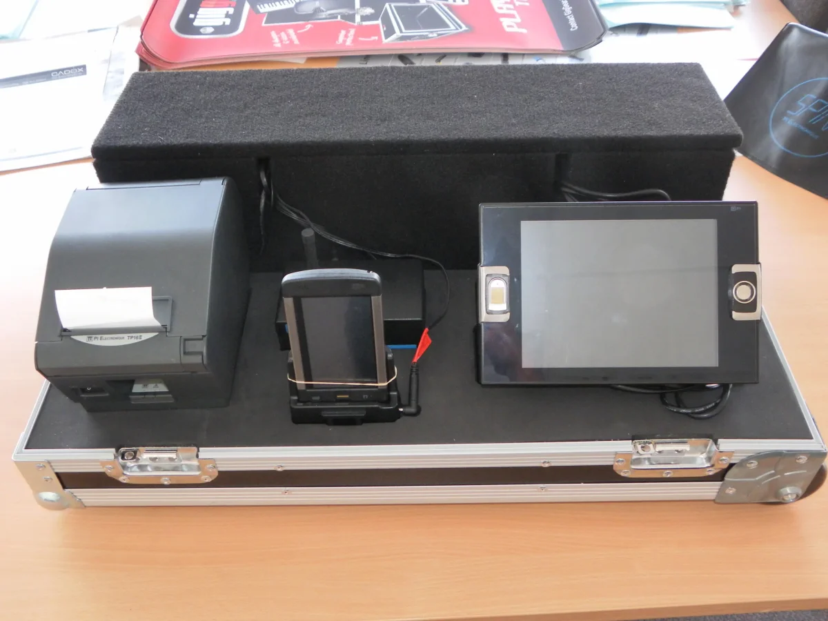 Shallow case fitted with a receipt printer, handheld dock and tablet in cut foam
