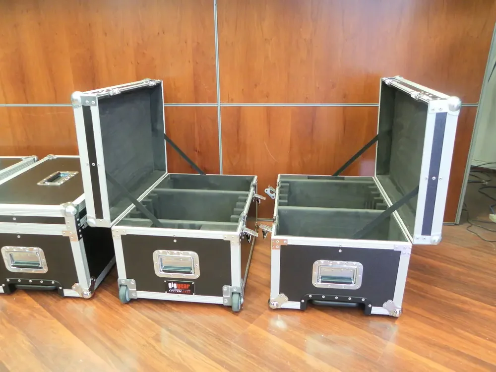 Three open flight cases showing foam divided interiors and lid straps