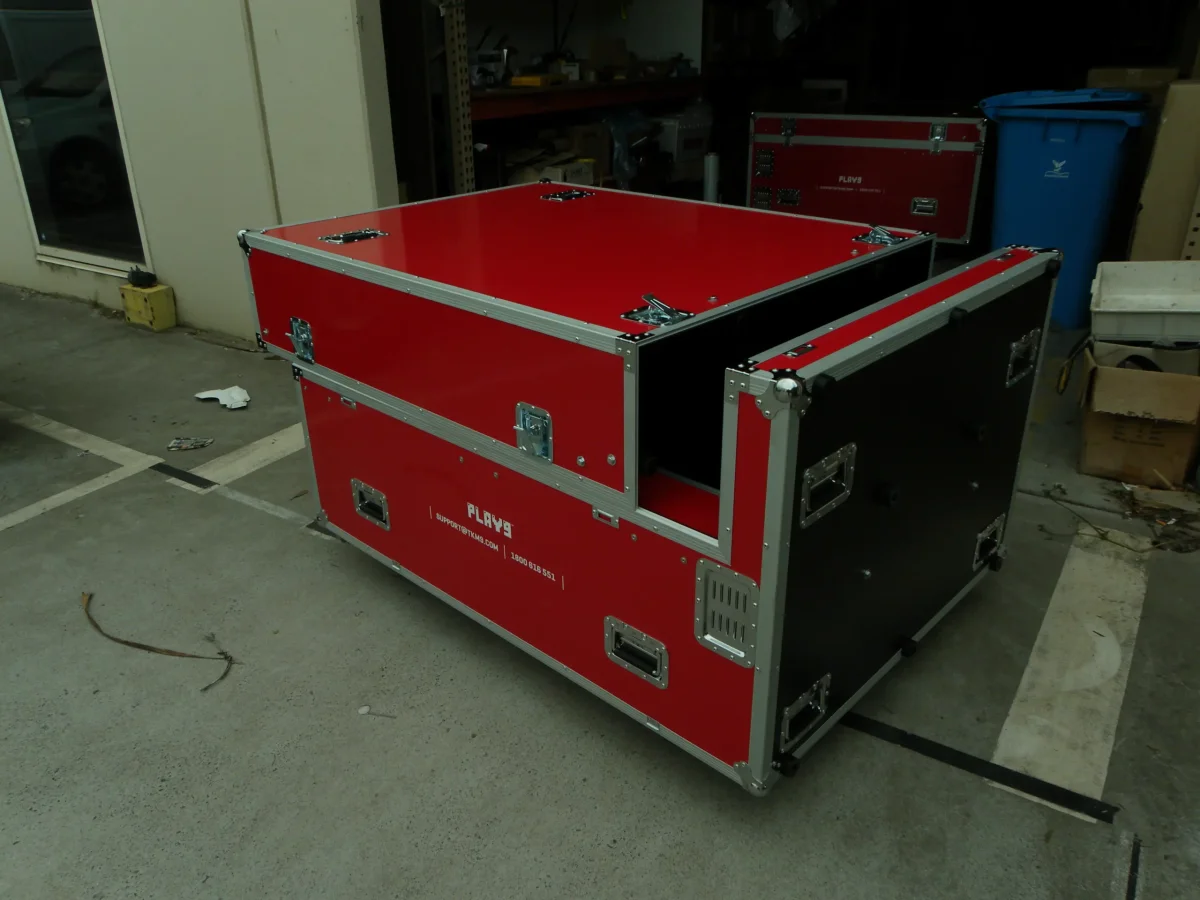 Red road case opened up showing the black lined interior and removable end panel
