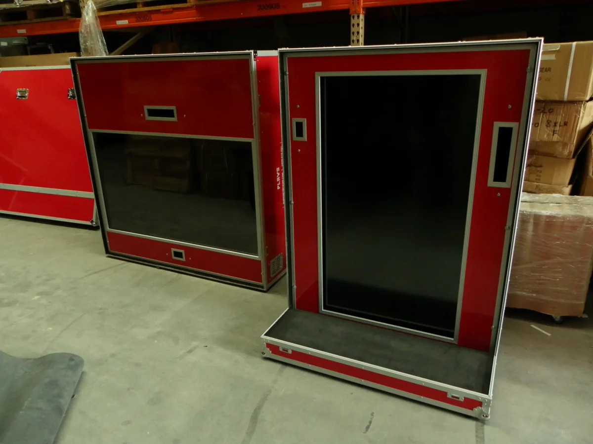 Two red screen cases, one opened out as a floor-standing display frame