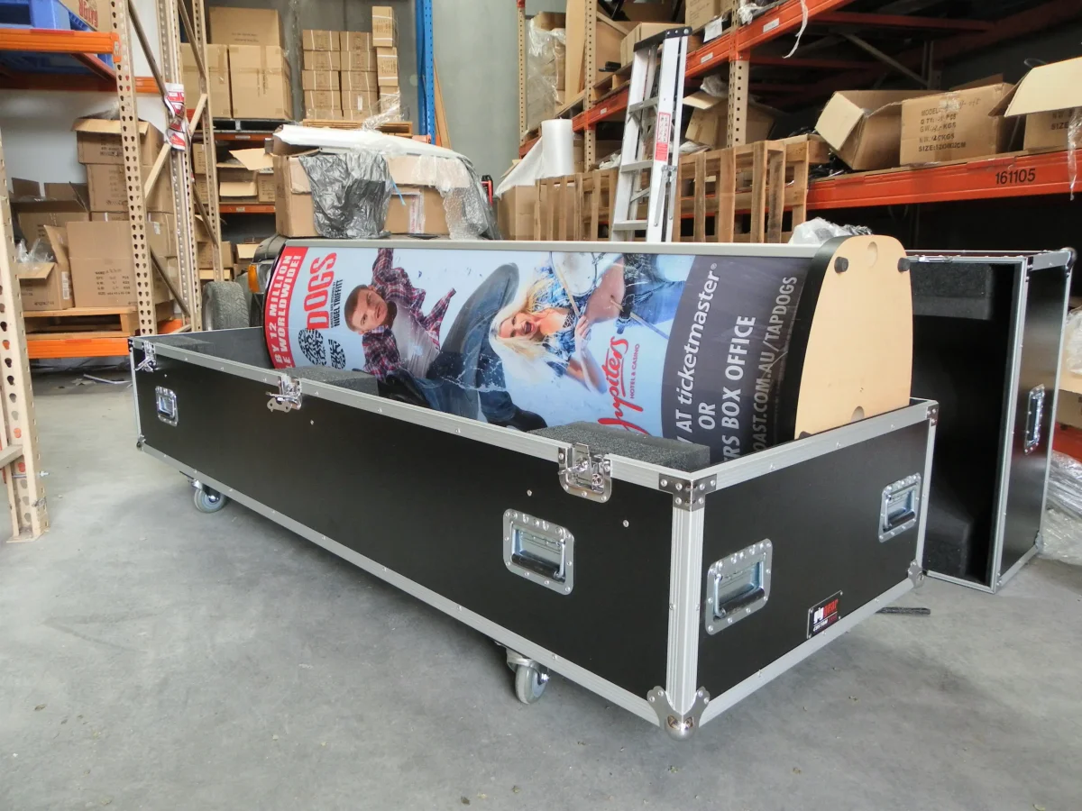 Open long case holding a rolled banner display and shaped timber end supports