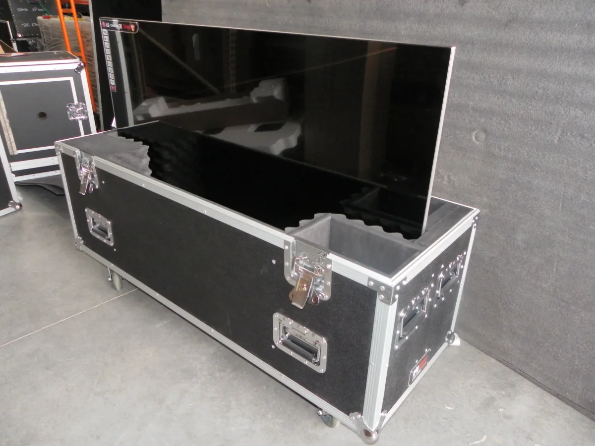 Open TV road case with a large flat panel seated in cut foam