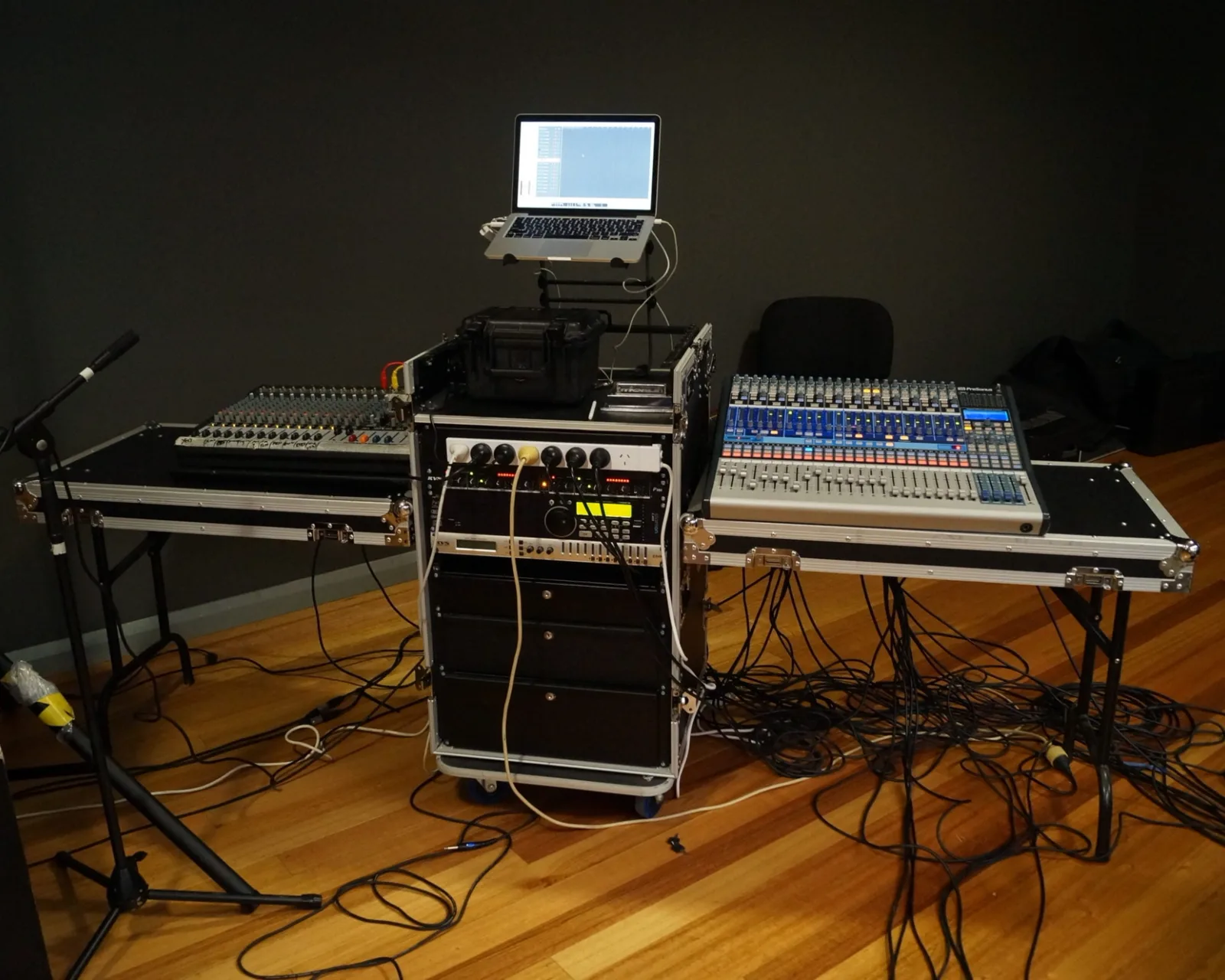 16U workstation rack case with both lids folded out into trestle tables, holding a mixing console and rack gear